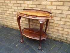 An occasional table with removable butlers tray, on ball and claw supports,