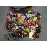 A collection of Girl Guide and Boy Scout badges and belts.
