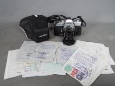 A Minolta SRT 101b camera with a collection of passport visa pages 1950's and later.