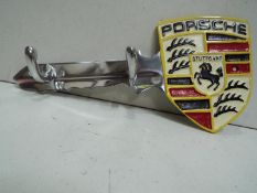 White metal key shape coat rack / key holder, marked Porsche Stuttgart.