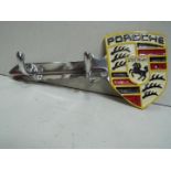 White metal key shape coat rack / key holder, marked Porsche Stuttgart.