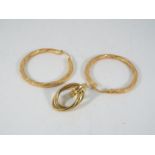 A pair of 9ct gold hoop earrings and one further 9ct gold earring, approximately 2.8 grams all in.
