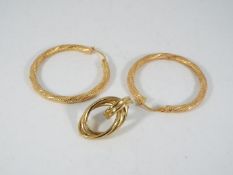 A pair of 9ct gold hoop earrings and one further 9ct gold earring, approximately 2.8 grams all in.