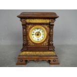 A Late 19th century oak-cased musical alarm clock,