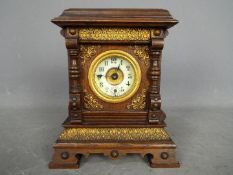 A Late 19th century oak-cased musical alarm clock,