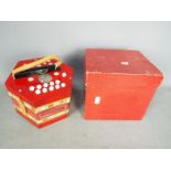 A boxed Scholer concertina.