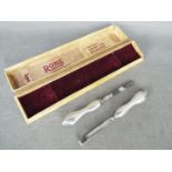 Two silver handled nail care tools,