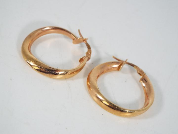 A pair of 9ct rose gold, Italian hoop earrings, approximately 2 grams all in. - Image 2 of 3