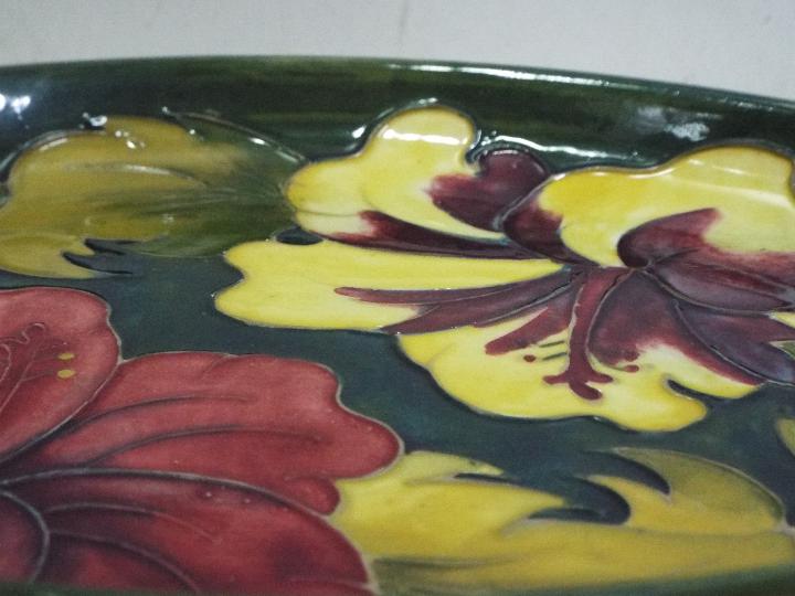 William Moorcroft "Hibiscus" Green oval dish, reds and yellows on a green ground. - Image 2 of 4