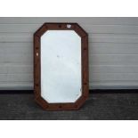 A wood framed, bevel edged mirror, approximately 52 cm x 82 cm.