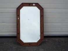 A wood framed, bevel edged mirror, approximately 52 cm x 82 cm.