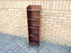 A small freestanding bookcase measuring approximately 118 cm x 31 cm x 24 cm.