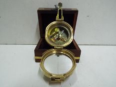 Saltney London - Compass (Brass). Fitted wooden box with brass inlay, anchor design on top.