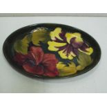 William Moorcroft "Hibiscus" Green oval dish, reds and yellows on a green ground.