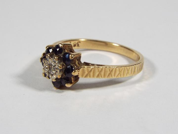 A 9ct yellow gold diamond and sapphire cluster ring, size M, approximately 2. - Image 4 of 6