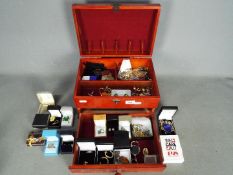 A jewellery box containing a collection of costume jewellery and similar,