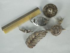 A quantity of silver brooches and a silver comb