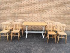 A pine kitchen table, six chairs and two carvers.