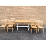 A pine kitchen table, six chairs and two carvers.