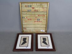 A framed Victorian needlework sampler and two framed Arthur Forrester profile silhouettes,