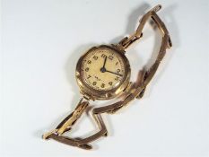 A 9ct gold cased lady's wristwatch on 9ct expanding bracelet.