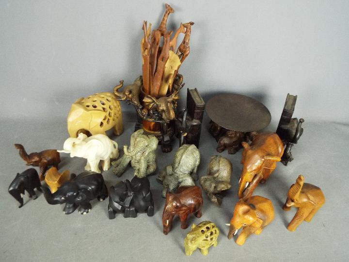 A herd of elephant figurines, carvings and similar.