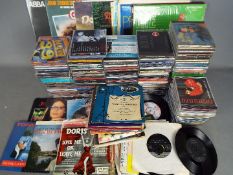 A collection of CD's of varying genre and a small quantity of vinyl records.