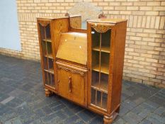 A mirror back sideboard bureau measuring approximately 148 cm x 122 cm x 33 cm.