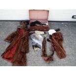 A vintage suitcase containing a quantity of furs,