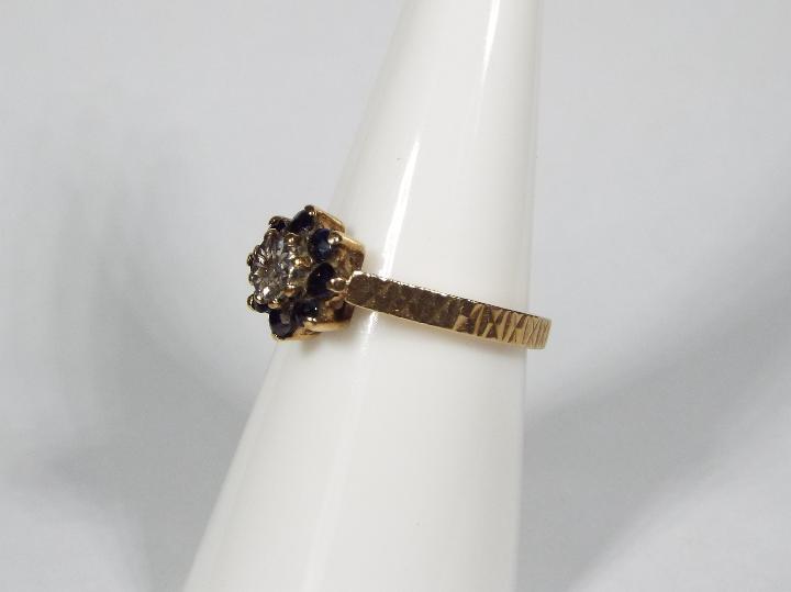 A 9ct yellow gold diamond and sapphire cluster ring, size M, approximately 2. - Image 2 of 6