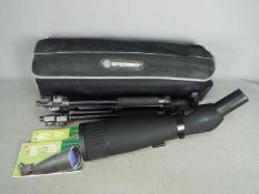 A Bresser spotting scope with tripod and soft case.