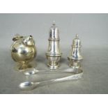 Two hallmarked silver cruets, a pair of silver tongs and a further twin section plated cruet.