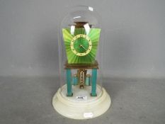 A rare Art Deco 400-day torsion clock in green lacquer finish,