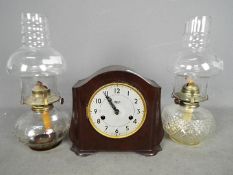 Two glass oil lamps and a bakelite cased Smiths mantel clock.