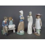 Four Spanish figurines, Nao and similar, largest approximately 22 cm (h).