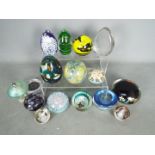A collection of paperweights to include Caithness, Perthshire, Mdina, Wedgwood,