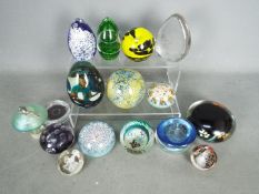 A collection of paperweights to include Caithness, Perthshire, Mdina, Wedgwood,