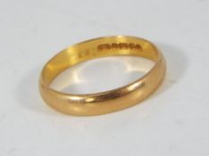 A 22ct gold wedding band, size P, approximately 3.2 grams all in.