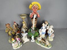 A collection of capodimonte and similar figurines and models.