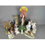 A collection of capodimonte and similar figurines and models.