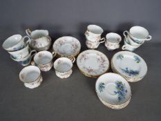 A collection of tea wares comprising 19 pieces of Paragon 'Victoriana Rose' and 18 pieces of Crown