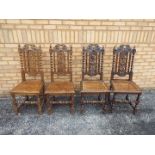 Four highly carved oak chairs.
