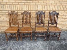 Four highly carved oak chairs.