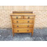 A chest of two over three drawers on cas