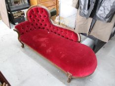 An upholstered chaise lounge, approximat