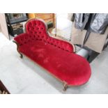 An upholstered chaise lounge, approximat