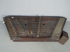 A 19th century hammered dulcimer, with hammers and tuner.