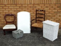 A mixed lot of furniture to inclue two chairs, a mirror and two storage baskets,