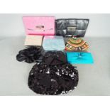 A collection of lady's evening bags, some still with tags, appear generally unused.