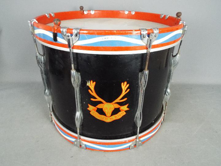 A regimental style marching drum printed with the Gaelic motto Cuidich'n Righ (trans Help the King)